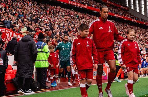 news Liverpool fan Max leads team onto pitch at Anfield Max and Virgil had a kickabout in front of the Kop before the game began